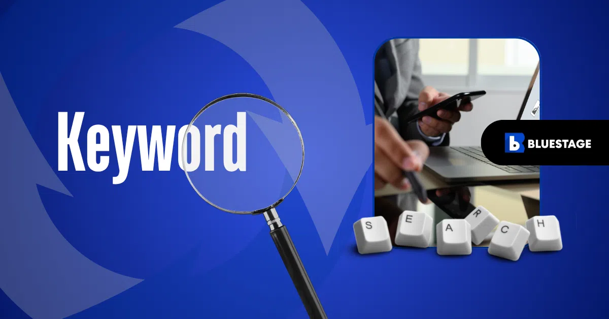 Magnifying glass over the word Keyword, person using phone and laptop representing a digital marketing agency, with keyboard keys spelling SEARCH and Bluestage logo on a blue background.